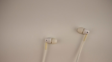 white headphones lie on a white background