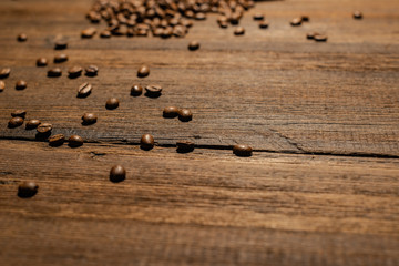 Freshly roasted coffee beans close-up on a dark ninety background backdrop. Coffee beans texture