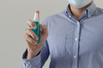 Front view of man holding alcohol bottle spray , covid-19 and coronavirus