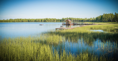 beautiful lake with houses and pavilions on the shore