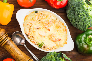 seafood baked rice，A plate of fresh seafood baked rice on the wooden tabl