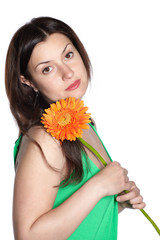 Portrait of a sad woman holding gerbera flower, isolated over white background