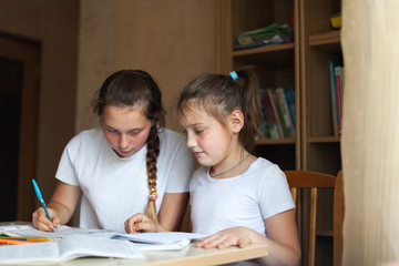 Sisters learning lessons at home.