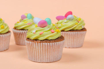 Bright pistachio Easter cupcakes with decorations close up