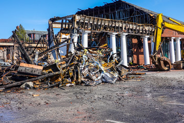 A one story building with white columns destroyed by fire full of debris - obrazy, fototapety, plakaty