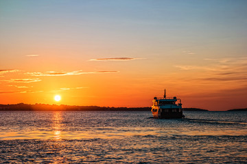 Fototapeta premium Sunset with ship sailing to the Brijuni Islands in Fazana, Croatia