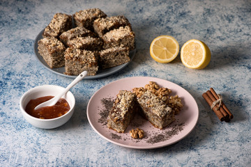 Homemade poppy seeds pie with with ingredients for baking on a rustic table, breakfast or dessert, 

traditional poppy pie with chopped walnuts and apricot jam - Top View