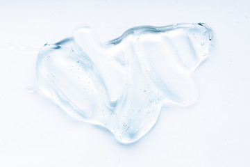 Fototapeta na wymiar Transparent liquid gel cream smudge on white background