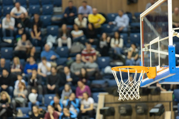 Basketball board and basket with fans in the background. Basketball basket in the background of the audience.