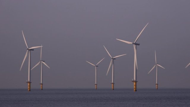 Offshore wind turbine farm off teesside North east England UK 4K