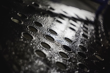wet metal surface with some holes