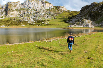 Boy walking towards the lake