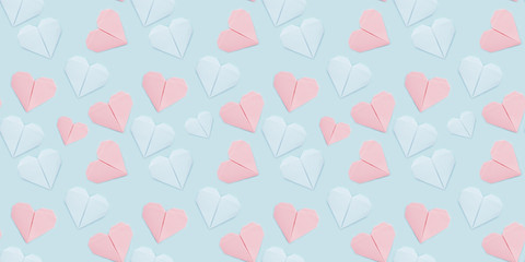 Fototapeta na wymiar Seamless pattern of paper origami hearts on a blue background. Valentine's day background, wedding concept . The hearts are blue and pink.