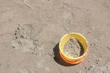 The yellow pail by the beach