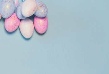 Decorative easter eggs on colorful pastel background.