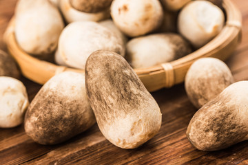 straw mushroom group on wooden background with