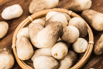 straw mushroom group on wooden background with