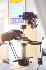 Hardness tester in laboratory, measures strength of metal.