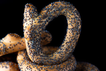 Bagels with poppy seeds on a dark background. Photographed close-up.