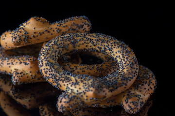 Bagels with poppy seeds on a dark background. Photographed close-up.