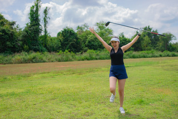 Portrait of golfer asian woman holding golf wood at the country club,Happy woman concept