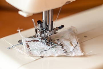 The mechanism of the sewing machine on fabric