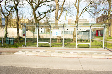 Bus stop for public transport with trees in the background in Nijmegen, Netherlands
