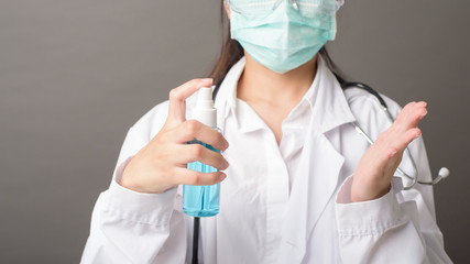 woman doctor is using hand sanitizer