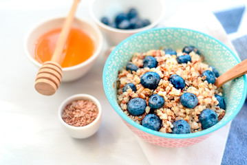Healthy romantic breakfast with pumpkin porridge and berries at village summer house