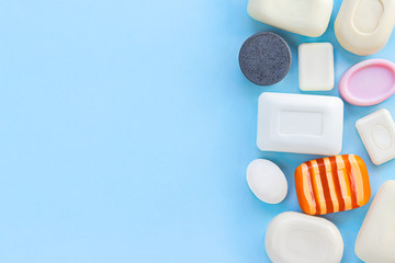 Many different types of soap bars on blue background. Wash your hands, antiviral protection. Top view, space for text