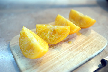 Boiled orange sliced on a wooden board