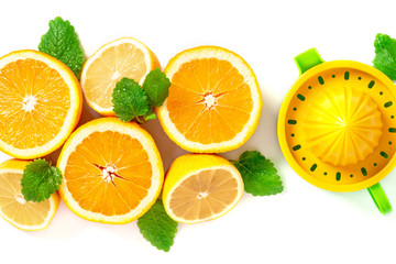 Halves of citrus, mint leaves and a juicer on a white background, top view, copy space. Lemons,...