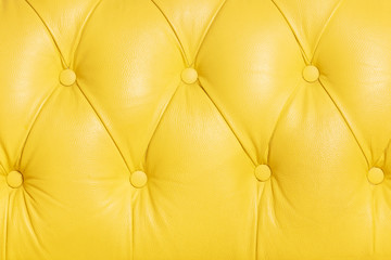 Yellow background pattern of a chesterfield leather sofa