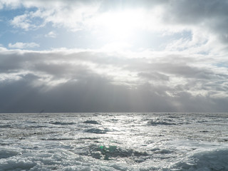 Scenery of a beautiful cloudy sky over an ice-covered pond