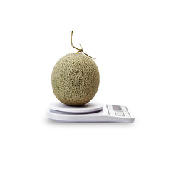 Fruit cantaloupe melon on Kitchen scales