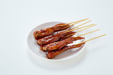 Thai food with grilled chicken wings on white