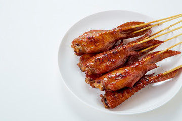 Thai food with grilled chicken wings on white