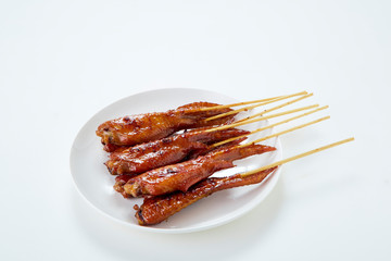 Thai food with grilled chicken wings on white