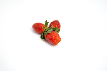 Red and fresh strawberries isolated on white