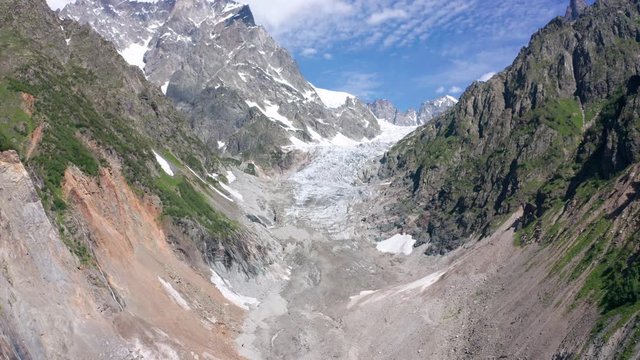 Caucasus Mountains on the border of Russia and Georgia. Chalaat Pass and Very beautiful view of the Chalaadi Glacier, Mount Ushba and Mestiachala river with background of clear blue sky.