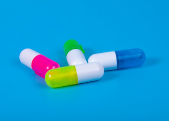 Different pills on blue background