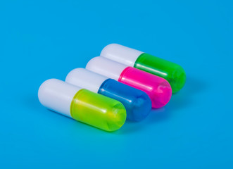 Different pills on blue background