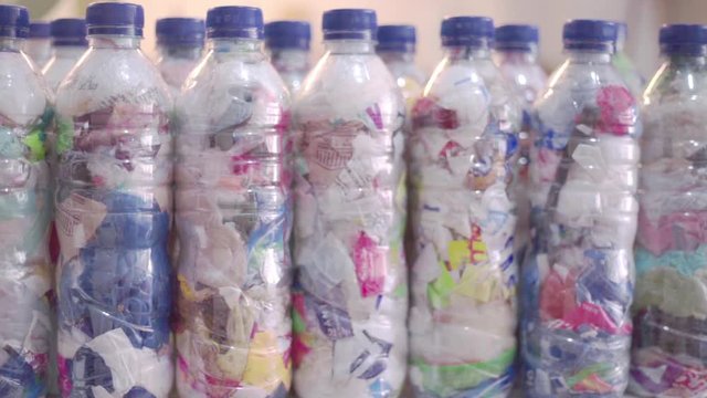 Dolly shot of a collection of fully finished high-quality ecobricks