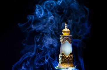 glass perfume bottle smoke dark background 