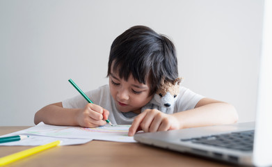 Happy kid having fun watching cartoon on tablet, Child using digital pad searching the ideas on...
