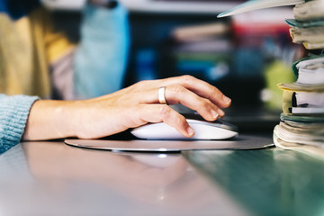 closeup of a female hand clicking computer mouse