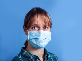 woman wearing facial mask for protection from air pollution or virus epidemic on blue background
