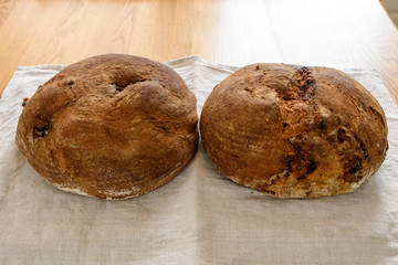 Two round freshly made sourdough bread with fig and hazelnuts.