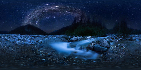the milky way arc over mountain river in the middle of the forest on a long exposure. Spherical...