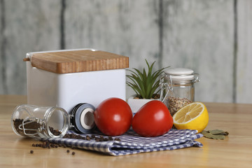 fresh vegetables on the kitchen table. Tomato,  jar of salt and pepper. Breakfast
